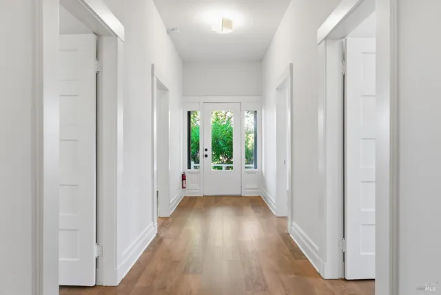 a view of an empty room with wooden floor