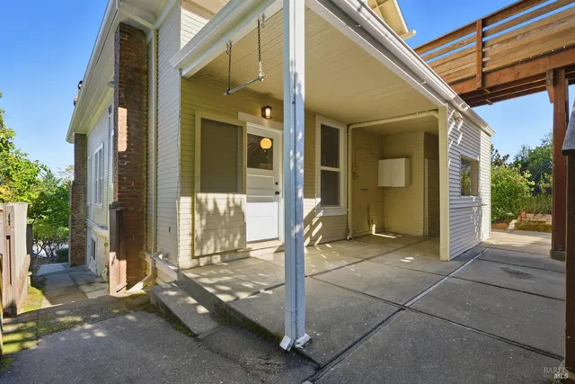 a view of a backyard with plants and wooden fence