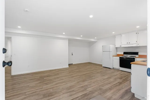 a backyard of a house with plants and tree