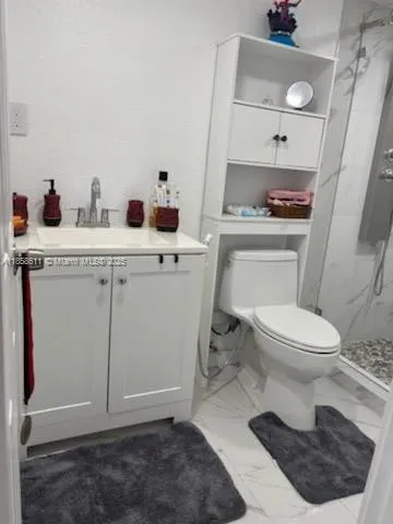 a bathroom with a toilet a sink and a mirror