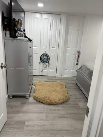 a room with wooden floor and cabinets