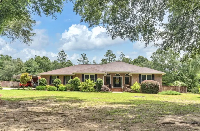a front view of a house with garden