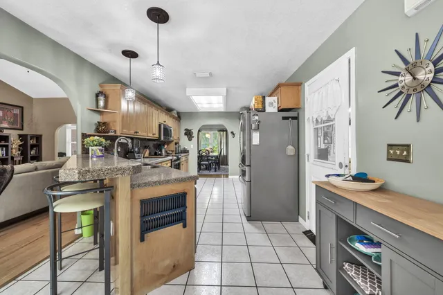 a kitchen with stainless steel appliances granite countertop a stove sink and cabinets