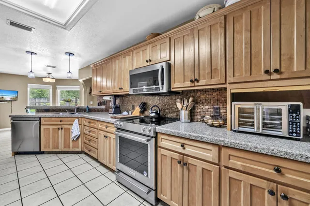 a kitchen with stainless steel appliances granite countertop a sink and cabinets