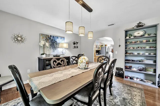 a bedroom with a bed a table and chair