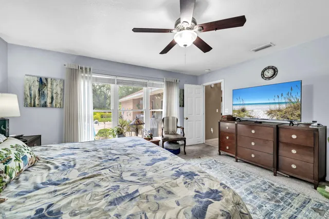 a bedroom with a bed couch and window