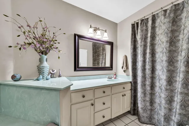 a bath tub sitting next to a bathroom sink