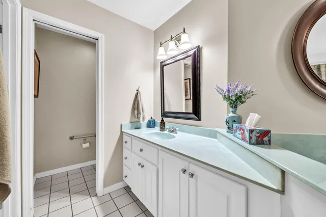 a en suite bathroom with a double vanity sink and a mirror