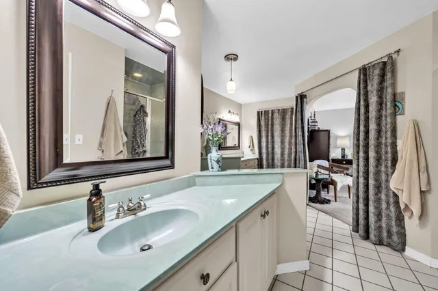 a bathroom with a shower and a glass door