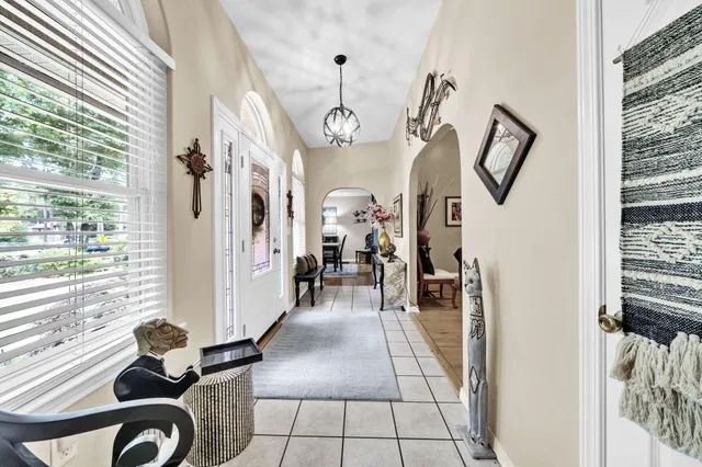 a very nice looking room with a large window and chandelier