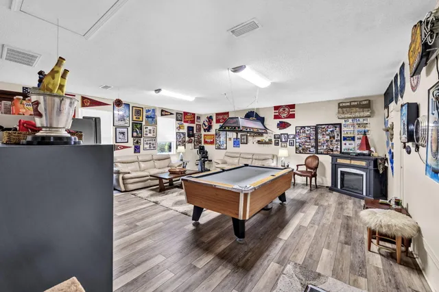 a living room with furniture a flat screen tv and a table