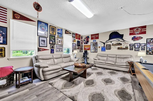 a living room with furniture and kitchen view