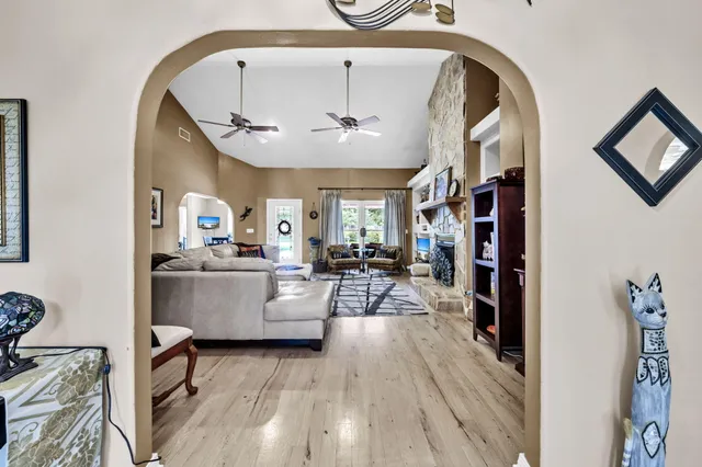a living room with furniture and a wooden floor