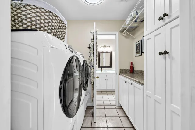 a kitchen with a sink dishwasher stove and white cabinets