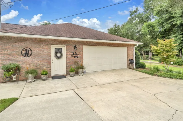 a view of backyard with table and chairs and a large tree