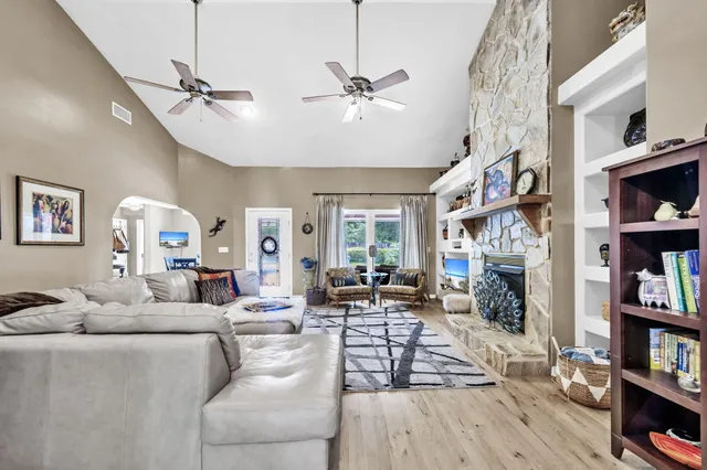 a living room with fireplace furniture and a book shelf