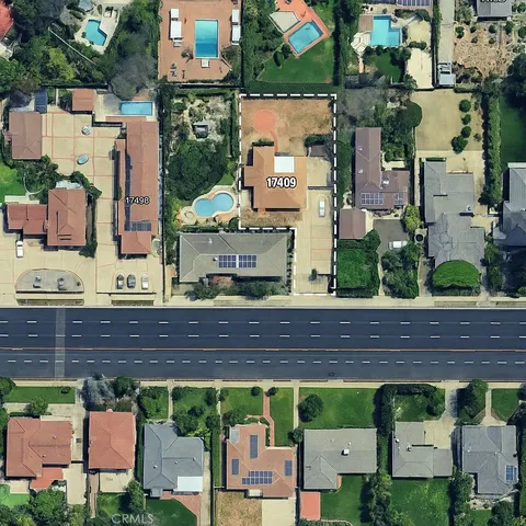 an aerial view of a house with a garden and outdoor seating
