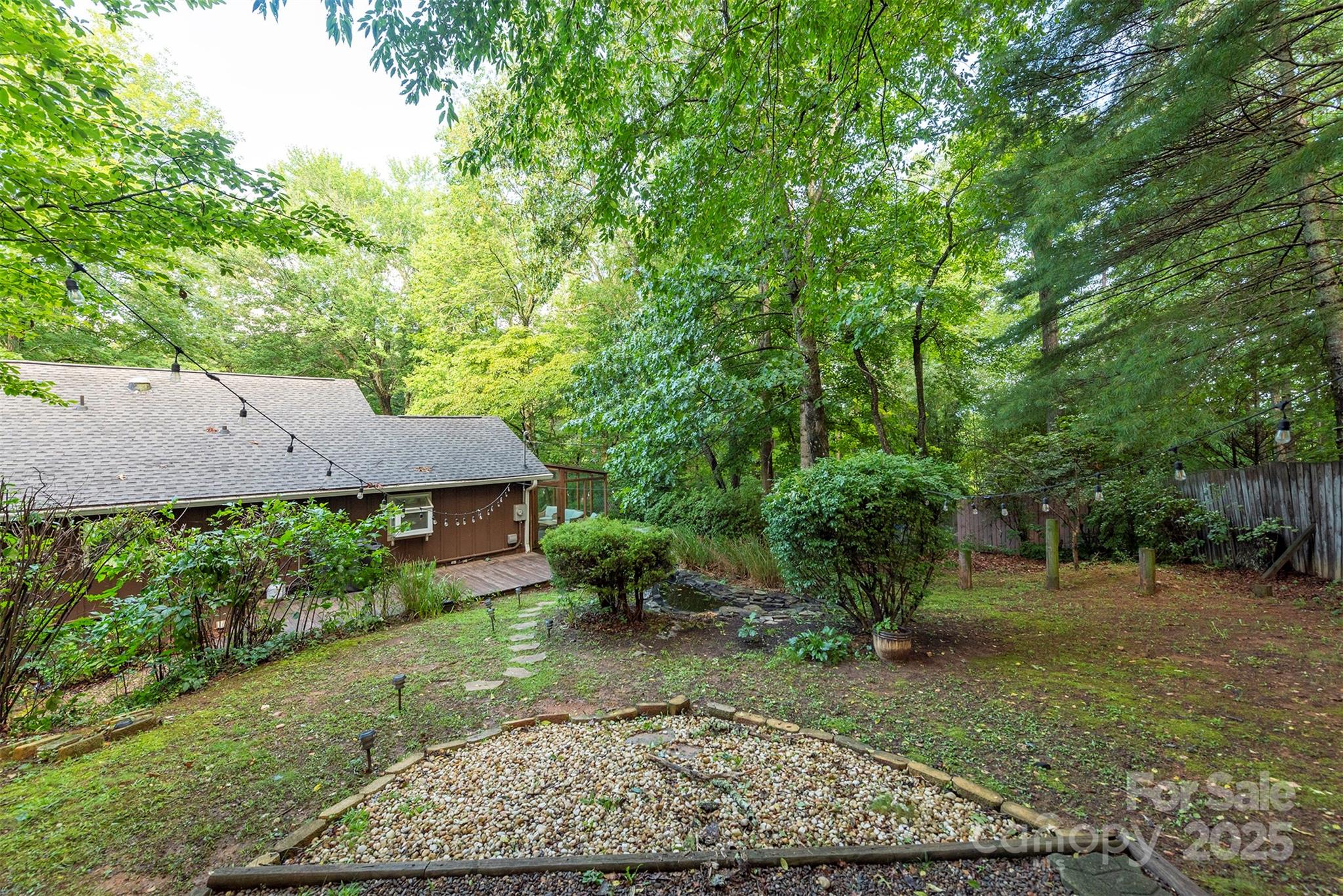 269 Newfound Road Leicester, NC 28748 - Photo 33 of 35 a view of a backyard with plants and large trees