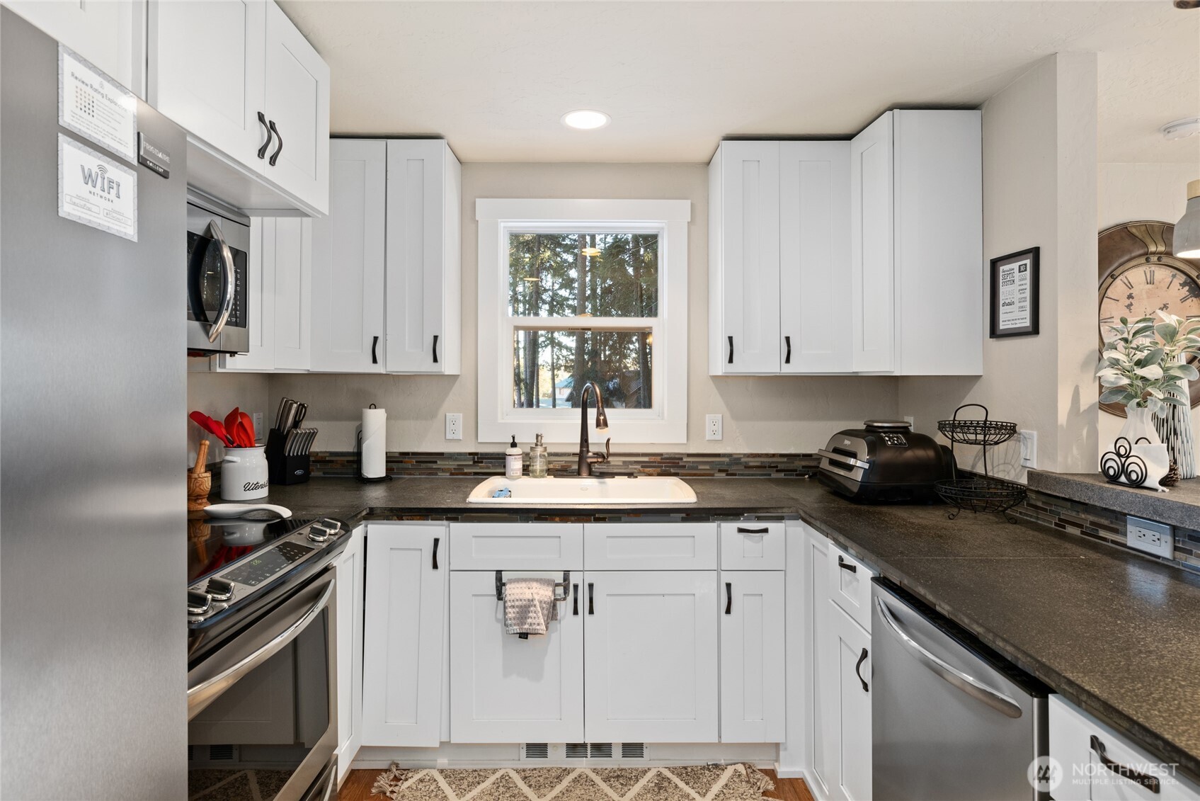 661 Pacific Avenue Ronald, WA 98940 - Photo 15 of 38 a kitchen with stainless steel appliances granite countertop a sink stove and cabinets