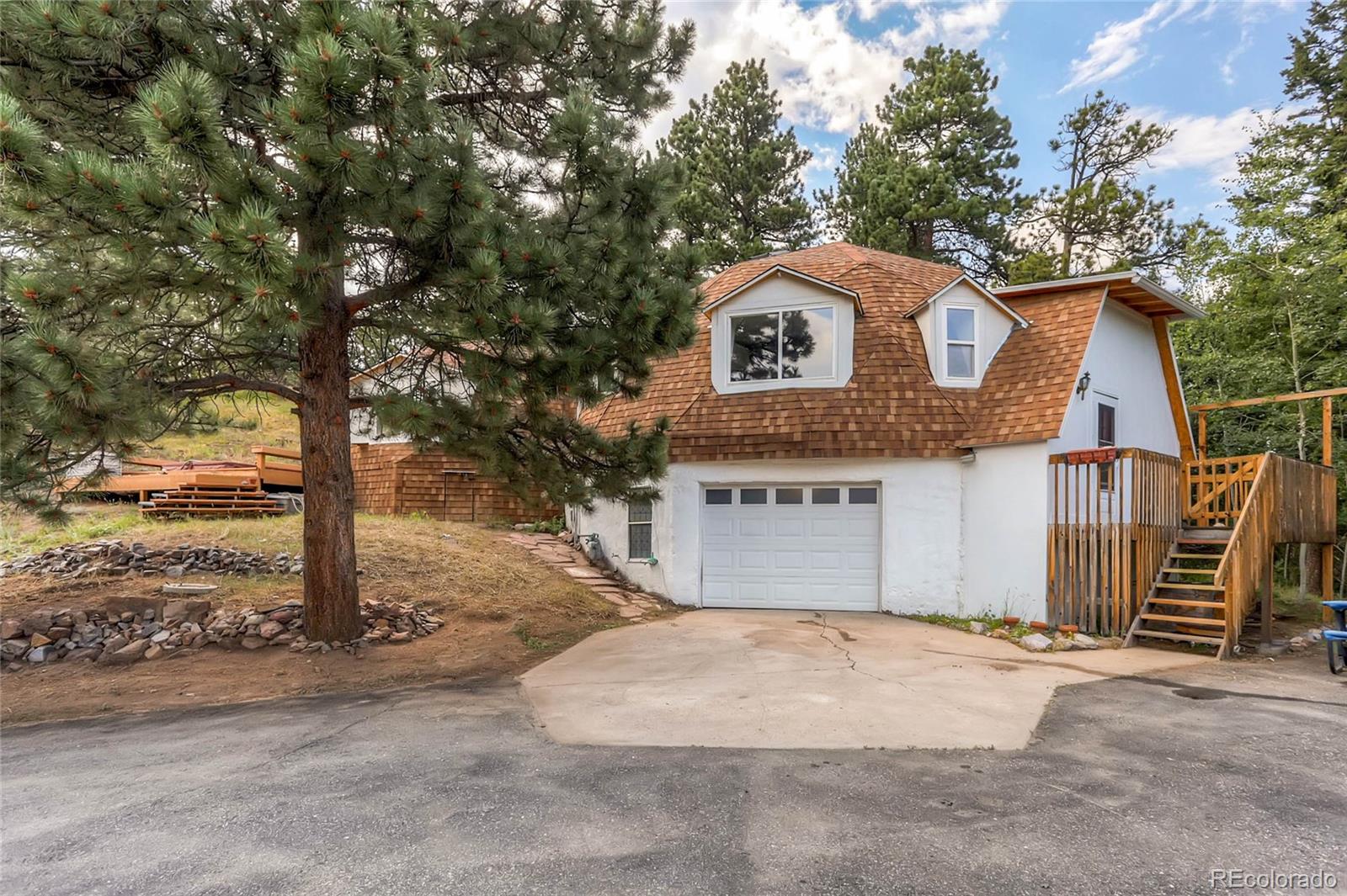11648 Ranch Elsie Road Golden, CO 80403 - Photo 1 of 13 a view of a house with a outdoor space