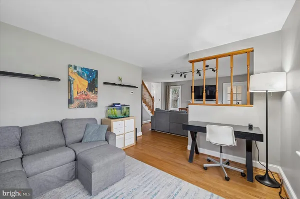 a living room with furniture a lamp and a potted plant