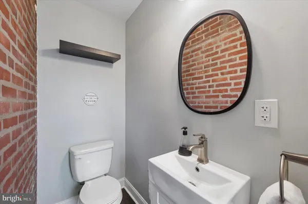 a bathroom with a toilet a sink and a mirror