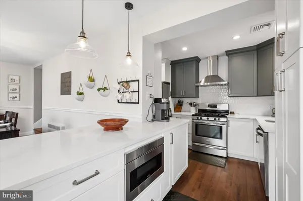 a kitchen with stainless steel appliances a stove a sink and a refrigerator