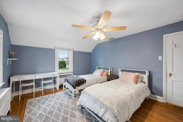 a bedroom with bed and wooden floor