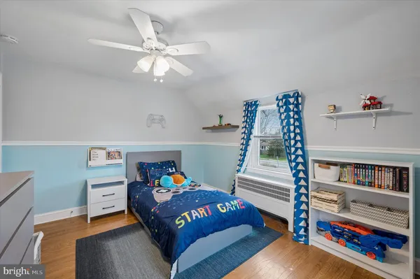 a bedroom with furniture and a book shelf