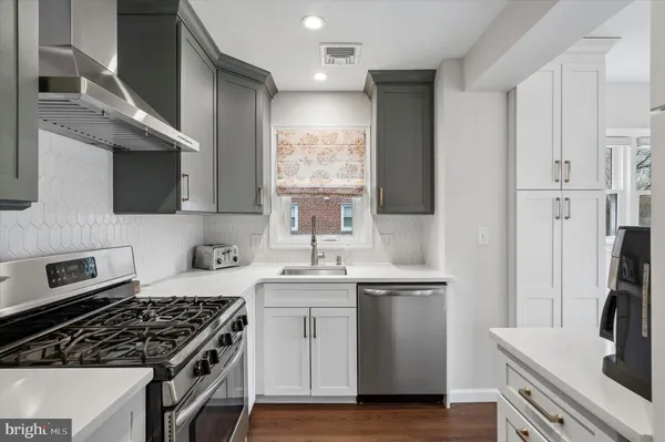 a kitchen with stainless steel appliances a sink stove and refrigerator