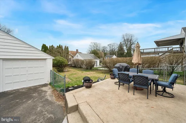 a view of a patio with couches chairs and potted plants