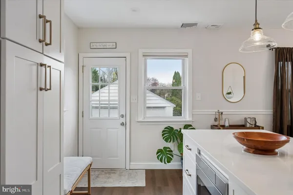 a bathroom with a granite countertop sink a mirror and a shower