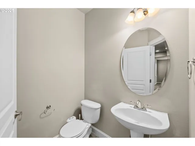 a bathroom with a sink toilet and mirror