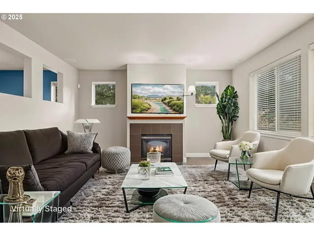 a living room with furniture a window and a fireplace