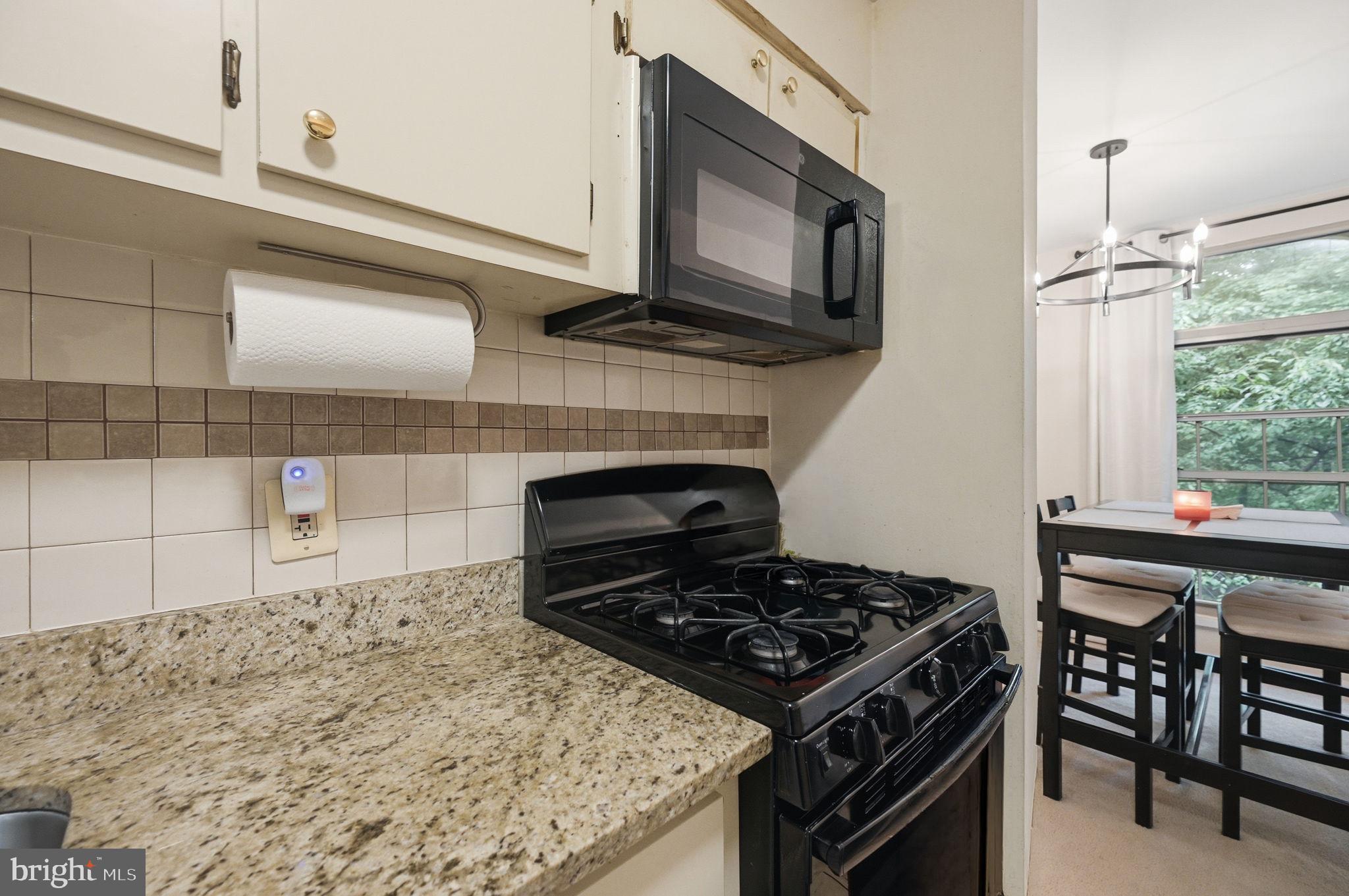 3366 Woodburn Road, Unit 23 Annandale, VA 22003 - Photo 4 of 16 a kitchen with a stove and a microwave