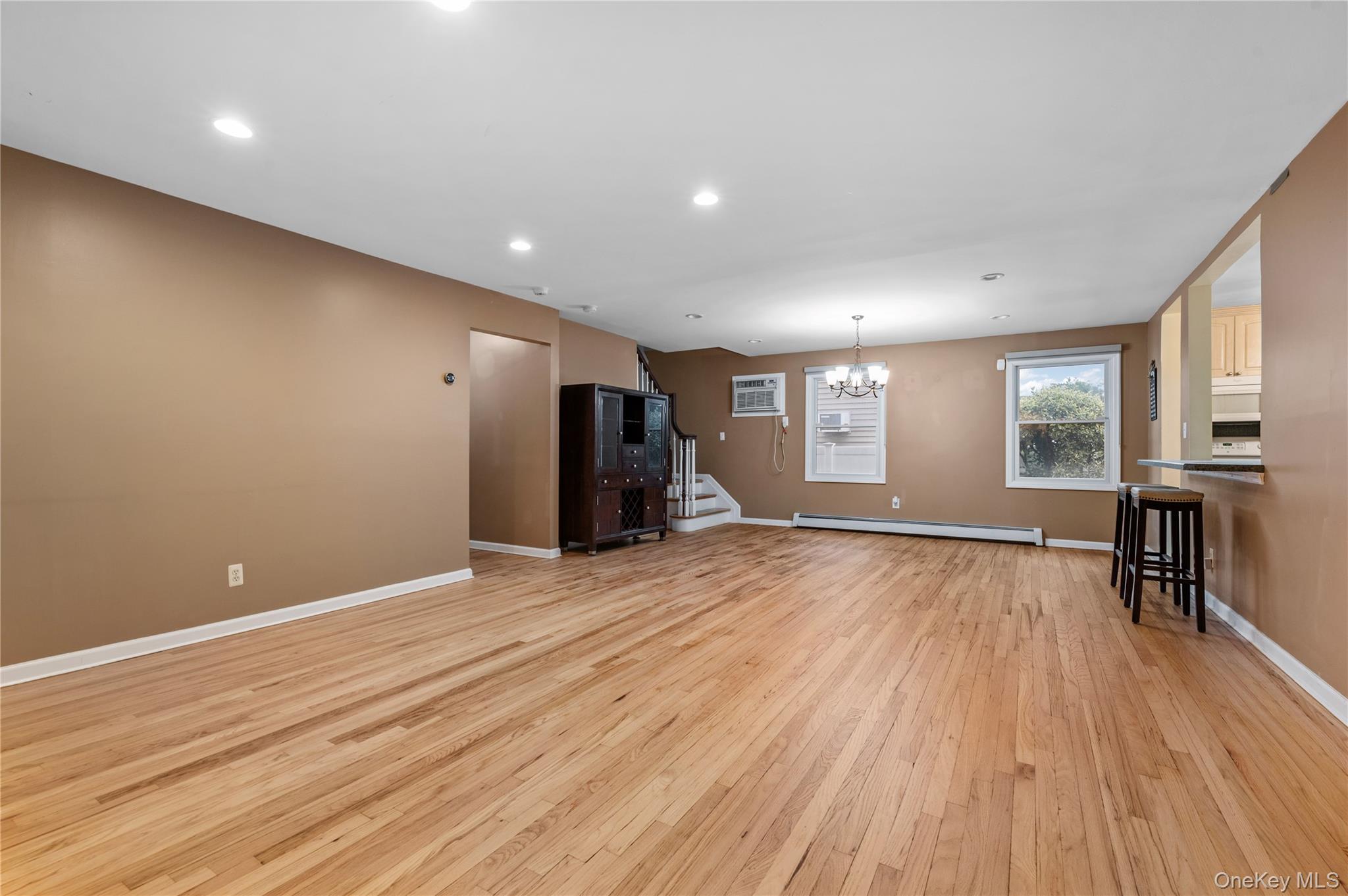 3 Cheshire Road Bethpage, NY 11714 - Photo 3 of 26 a view of an empty room with wooden floor and a window
