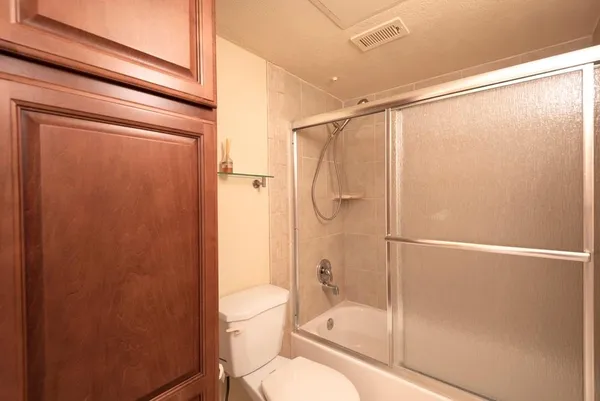 a bathroom with a shower a toilet and a shower