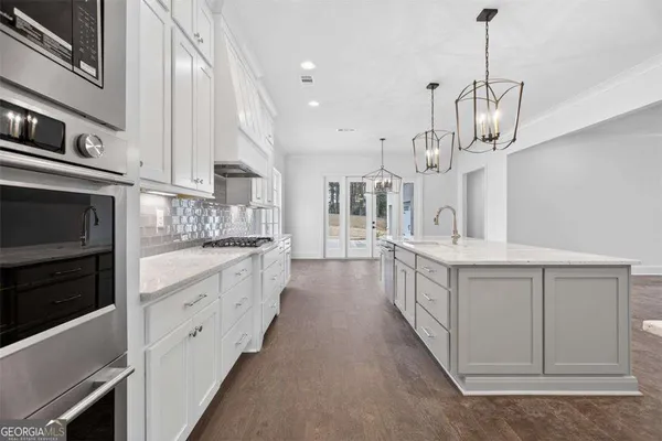a view of a kitchen with wooden floor and windows