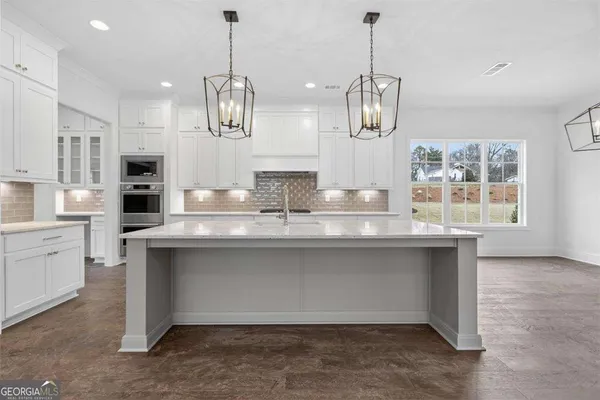 an empty room with windows and fireplace