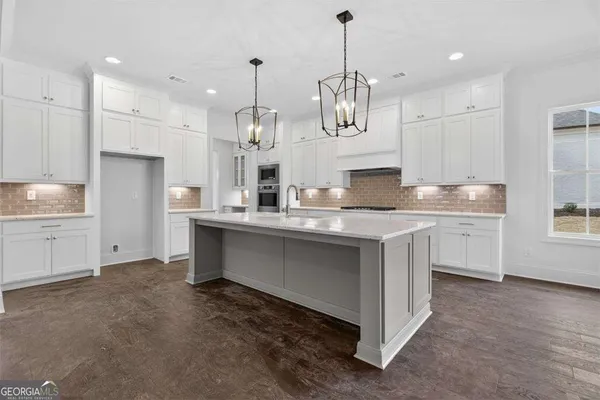 a view of a kitchen with a sink and cabinets