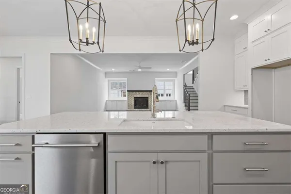 a view of a kitchen with cabinets and wooden floor