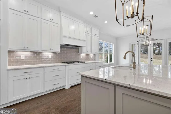 a bathroom with a granite countertop toilet and sink
