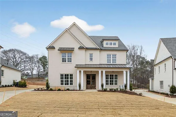a view of a livingroom with wooden floor and a large window