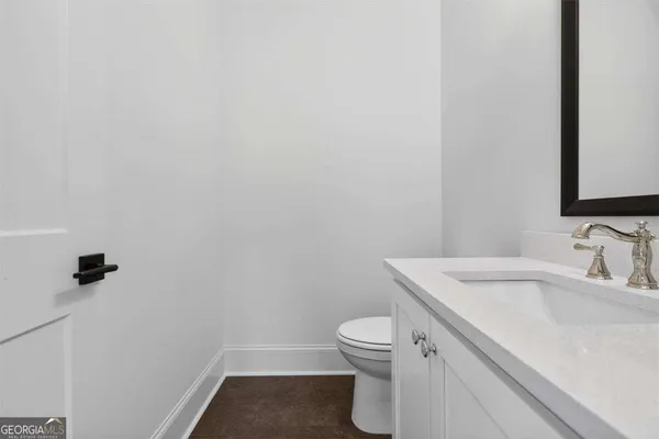 an empty room with windows and chandelier fan