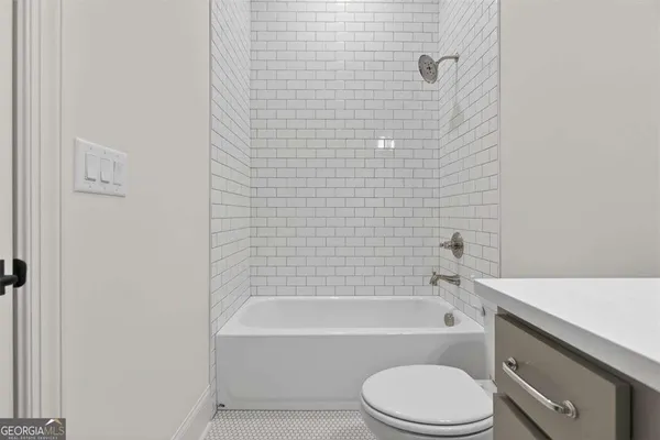 an empty room with windows and chandelier fan