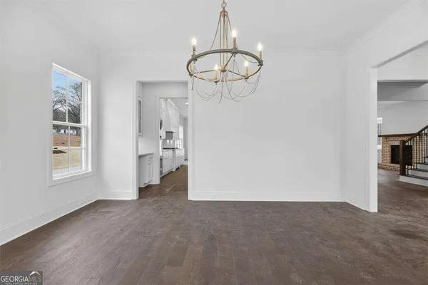 an empty room with fireplace and windows