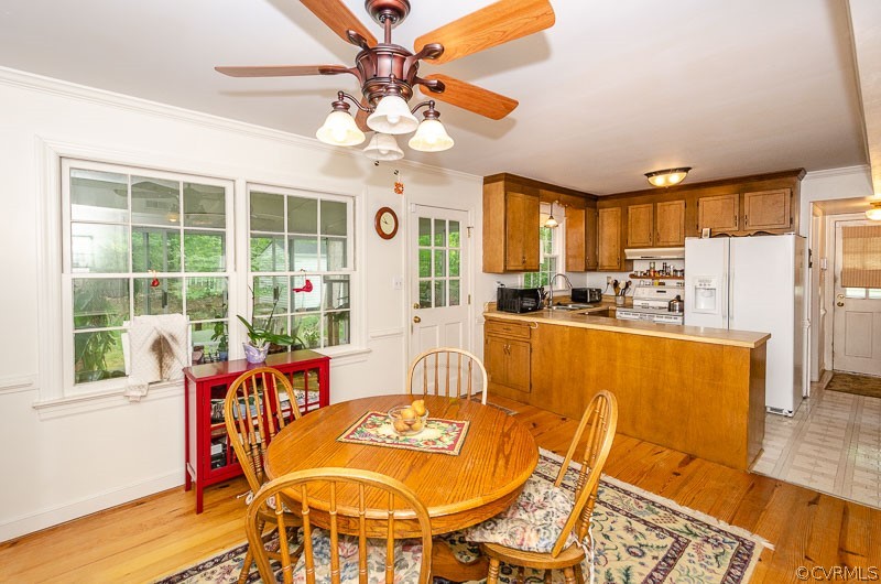 9724 Kendrick Road North Chesterfield, VA 23236 - Photo 13 of 38 a dining room with furniture a chandelier and wooden floor