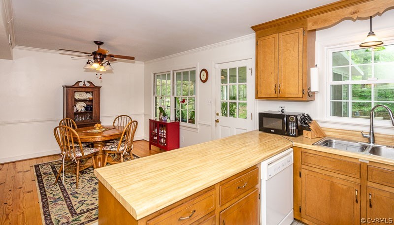 9724 Kendrick Road North Chesterfield, VA 23236 - Photo 17 of 38 a kitchen with stainless steel appliances granite countertop a stove a sink a dining table and chairs with wooden floor