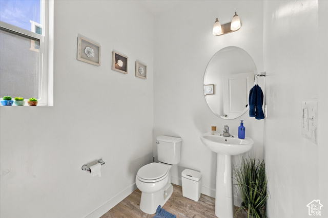 7939 Seattle Slew Road Eagle Mountain, UT 84005 - Photo 27 of 52 Pedestal sink with chrome faucet, oval mirror, and wall-mounted vanity lighting