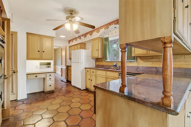 a kitchen with a refrigerator a sink and cabinets